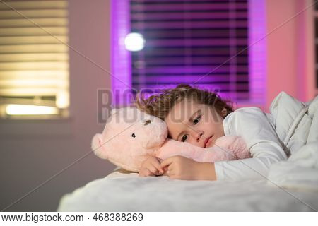 Child Cannot Sleep On Bed At Night In Bedroom. Kid Having Sleeplessness. Kid Boy Sleeping In Bed Wit
