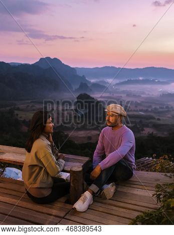 A Couple Watching The Sunrise With Fog At Phu Langka In Northern Thailand, Phu Langka National Park
