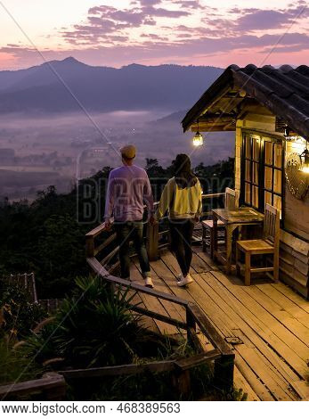 Couple Watching The Sunrise With Fog At Phu Langka In Northern Thailand, Phu Langka National Park