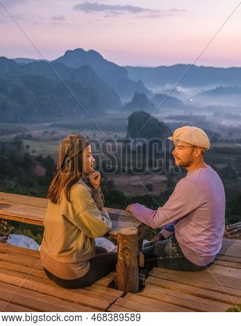 A Couple Watching The Sunrise With Fog At Phu Langka In Northern Thailand, Phu Langka National Park