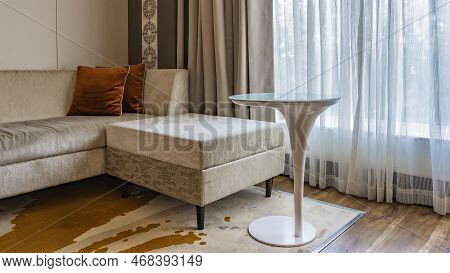 The Interior Of The Living Room. There Is A Sofa With Pillows In The Corner. Elegant Coffee Table On