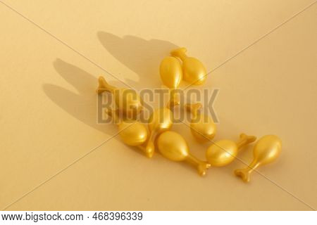 Capsules With A Cream Or Serum For Face Treatment On Beige Background. Single Dose Capsules For Beau