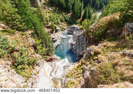 View From Above Of Lillaz Waterfall (cascate Di Lillaz) And Emerald Pond Below, Rocks Around Covered