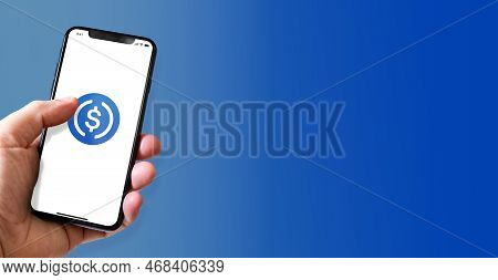 Paris - France - March 15, 2022 : Hand Holding Iphone Smartphone With Usdc Crypto Currency Logo. Hor