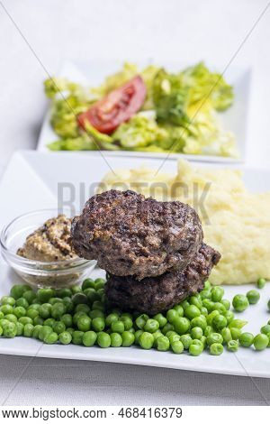 Bavarian Meat Loafs With Peas On White