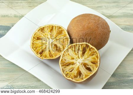 Dried Out Inedible Oranges Spoiled From Improper And Lengthy Storage On Plate