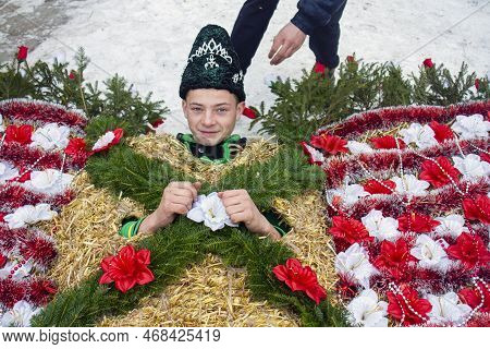 Krasnoilsk, Ukraine - 13 Jan 2017: Dressing A Young Boy In A Straw Bear Costume On Malanka. Malanka 