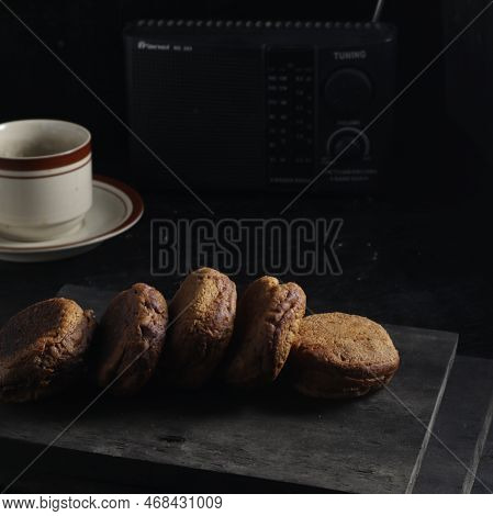 Apang Bale Cake Or Apang Bakar, And A Cup Of Tea Isolated On Black Background. Indonesian Cake