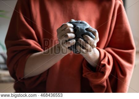 Woman Holding Piece Of Clay While Visiting Pottery Master Class, Learning How To Make Ceramics. Crop