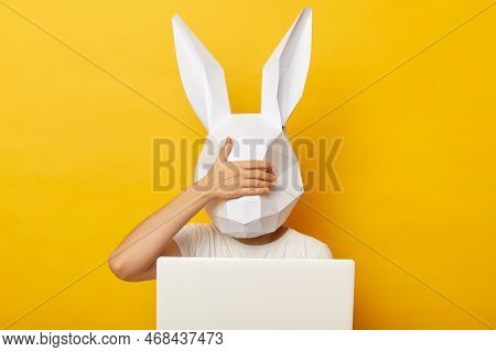 Indoor Shot Of Woman Wearing White T-shirt And Paper Rabbit Mask Standing Isolated Over Yellow Backg