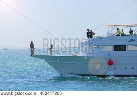 Hurghada - Egypt. 02 August 2018:
White Ship Is Sailing In The Sea. People Swim In Sea During Summer