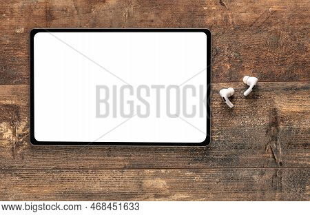 Mockup Tablet. Top View Of Blank Screen Tablet, Wireless Earphone On Old Rustic Wooden Table. Top Vi