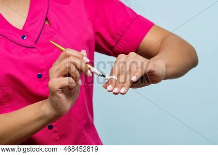 Hand Eyebrow Tattoo Artist Master Holds Tattoo Tool Maniple For Microblading. Non-caucasian Skinned 