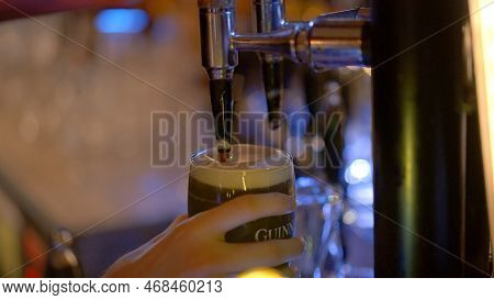 Draw A Fresh Guinness Beer In A Pub - City Of Dublin, Ireland - April 20, 2022