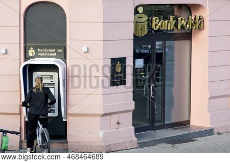 Bydgoszcz, Poland - August 10, 2022: Bank Polski Pko Office With A Young Woman Withdrawing Money Fro