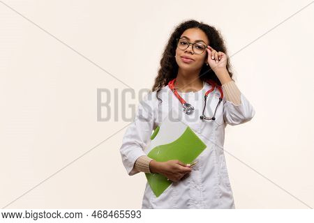 African American Woman Intern General Practitioner Hold Medical History Of Patient. Dark Skinned Fem