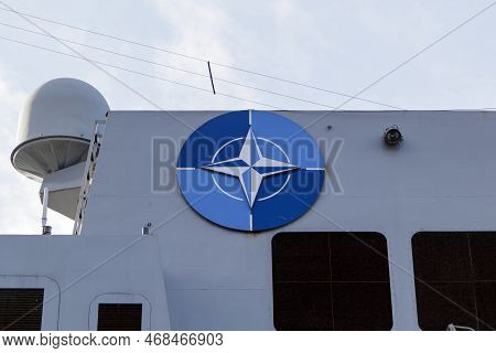 Nato Joint Military Symbology, A Dark Blue Field Charged With A White Compass Rose Emblem, With Four