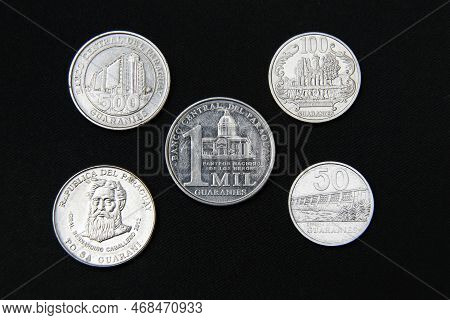 Paraguay Guaranies Coin - Set Of Paraguayan Coins In A Row Isolated On Black Background