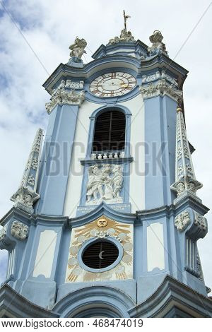 The Blue Color Church Spire With A Clock Of Historic 18th Century Durnstein Abbey In Wachau Region (