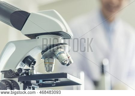 Science Microscope Equipment In Biology Chemical Laboratory. Scientific Experiment Microscope On Lab