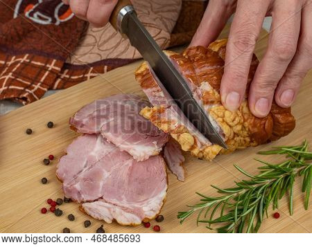 A Piece Of Juicy And Tasty Bacon Is Cut With A Kitchen Knife Into Appetizing Pieces. Close-up Of Fem