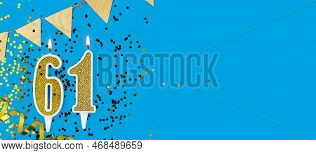 Golden Candle Number Sixty One. Birthday Or Anniversary Card With The Inscription 61 On Blue Backgro