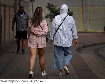 Szeged, Hungary - September 18, 2022: Selective Blur On Two Women, One Wearing Short Shorts And Bare