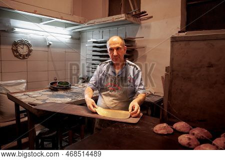 Istanbul, Turkey - May 21, 2022: Selective Blur On A Senior Man, A Pideci, A Baker, Preparing A Doug