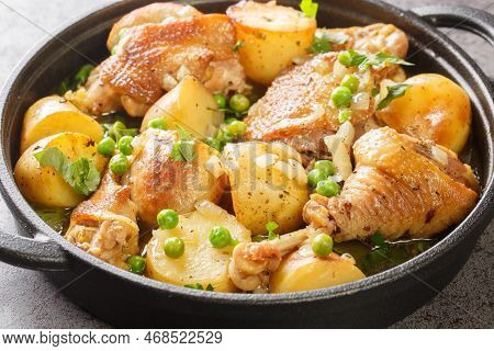 Italian American Cuisine Chicken Vesuvio A Skillet With Potatoes, Garlic, Green Peas Closeup On The 