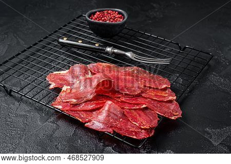 Dried Sliced Basturma, Cured Beef Meat Ready For Eat. Black Background. Top View.