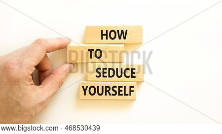How To Seduce Yourself Symbol. Concept Word How To Seduce Yourself On Wooden Blocks. Businessman Han