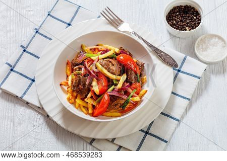 Lomo Saltado, Peruvian Dish Of Stir-fried Slices Of Beef Sirloin, Onions, Yellow Peruvian Chilis, An