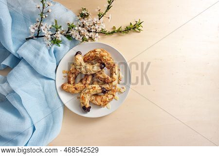 Almond Crescent Cookies On A Plate, Spring Flower Branch And Blue Napkin On A Light Wooden Table, La