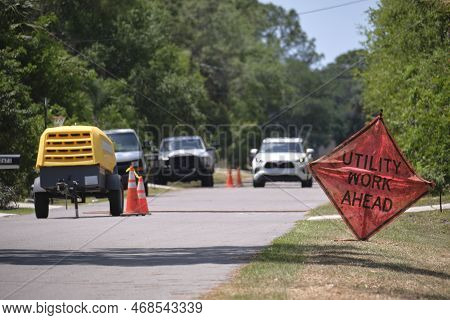 Road Work Ahead Sign On Street Site As Warning To Cars About Construction And Utility Works.