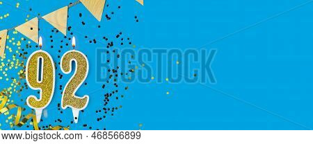 Golden Candle Number Ninety Two. Birthday Or Anniversary Card With The Inscription 92 On Blue Backgr