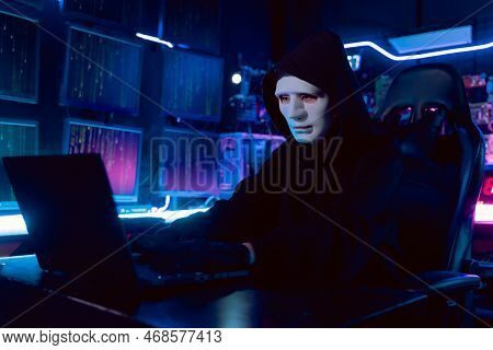 Female Asian Hacker In Hideout Place With Dark Environment And Multiple Displays And Cables, Trying 