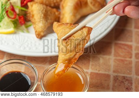 Chinese Wontons With Sweet Chilli Dip Sauce And Chop Sticks. Asian Fried Dumplings With Soy Sauce On