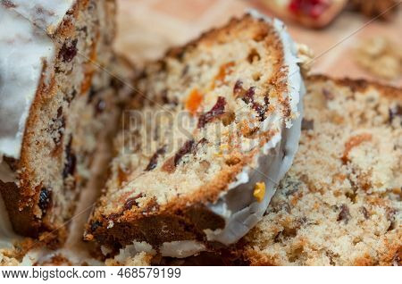 Christmas Stollen With Candied Fruit And Dried Fruits On Parchment. Stollen - Traditional German Bre