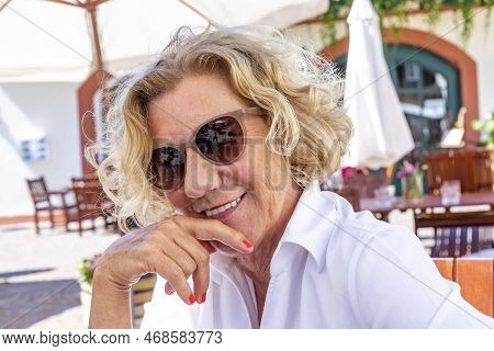 Outoor Portrait Of Attractive Happy Smiling Senior Woman With Blonde Hair