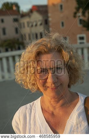 Portrait Of Attractive Causcasian Woman In Sunset In Summer With Curly Blonde Hair
