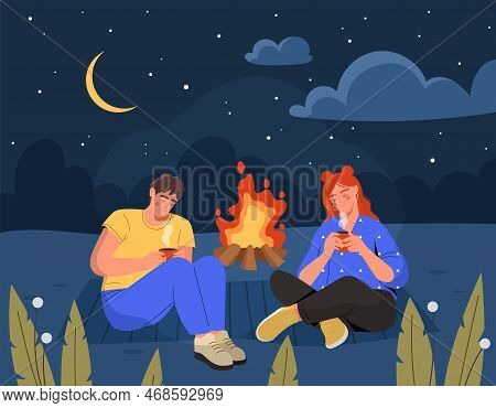 Camping In Forest. Man And Woman Sitting Near Campfire Outdoor At Night Under Starry Sky. Romantic D