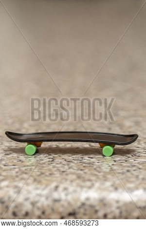 Fingerboard On A Neutral Background Of Marble Surface, Selective Focus. A Skateboard For Finger Skat
