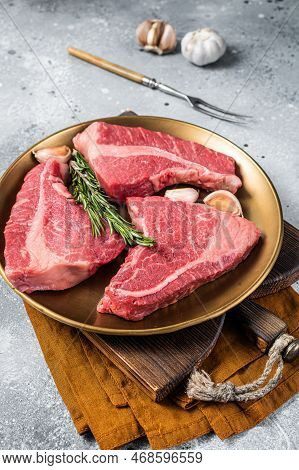 Raw Topside Sirloin Beef Cut On Steel Plate With Spices. Gray Background. Top View.