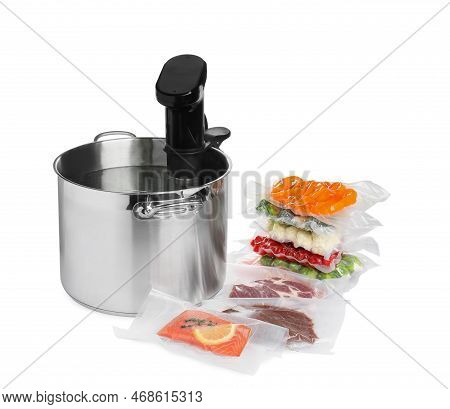 Thermal Immersion Circulator In Pot And Vacuum Packs With Different Food Products On White Backgroun