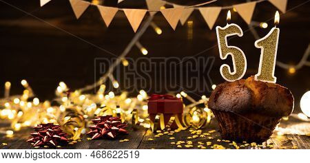 Number 51 Golden Festive Burning Candles In A Cake, Wooden Holiday Background. Fifty-one Years Since