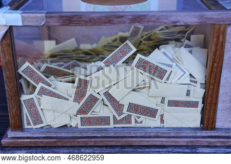 Playing 'omikuji' At A Japanese Shrine. Omikuji Is A Written Fortune-telling About The Person's Near
