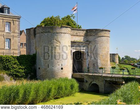 Bergues, France - July 5. 2022: An Old City Wall With Surveillance Towers, City Gate And Bridge, Cle