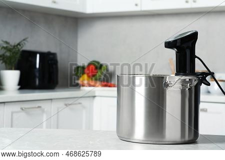 Pot With Sous Vide Cooker On Table In Kitchen, Space For Text. Thermal Immersion Circulator