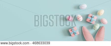 Blue Background With Easter Eggs, Rabbit Ears, Presents And Copy Space. Easter Backdrop. Empty Space