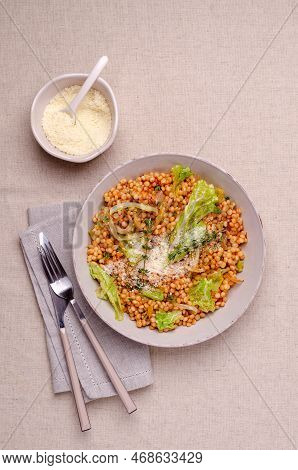Small Pasta With Vegetables In Tomato Sauce In A Ceramic Dish On A Textile Background. Top View.